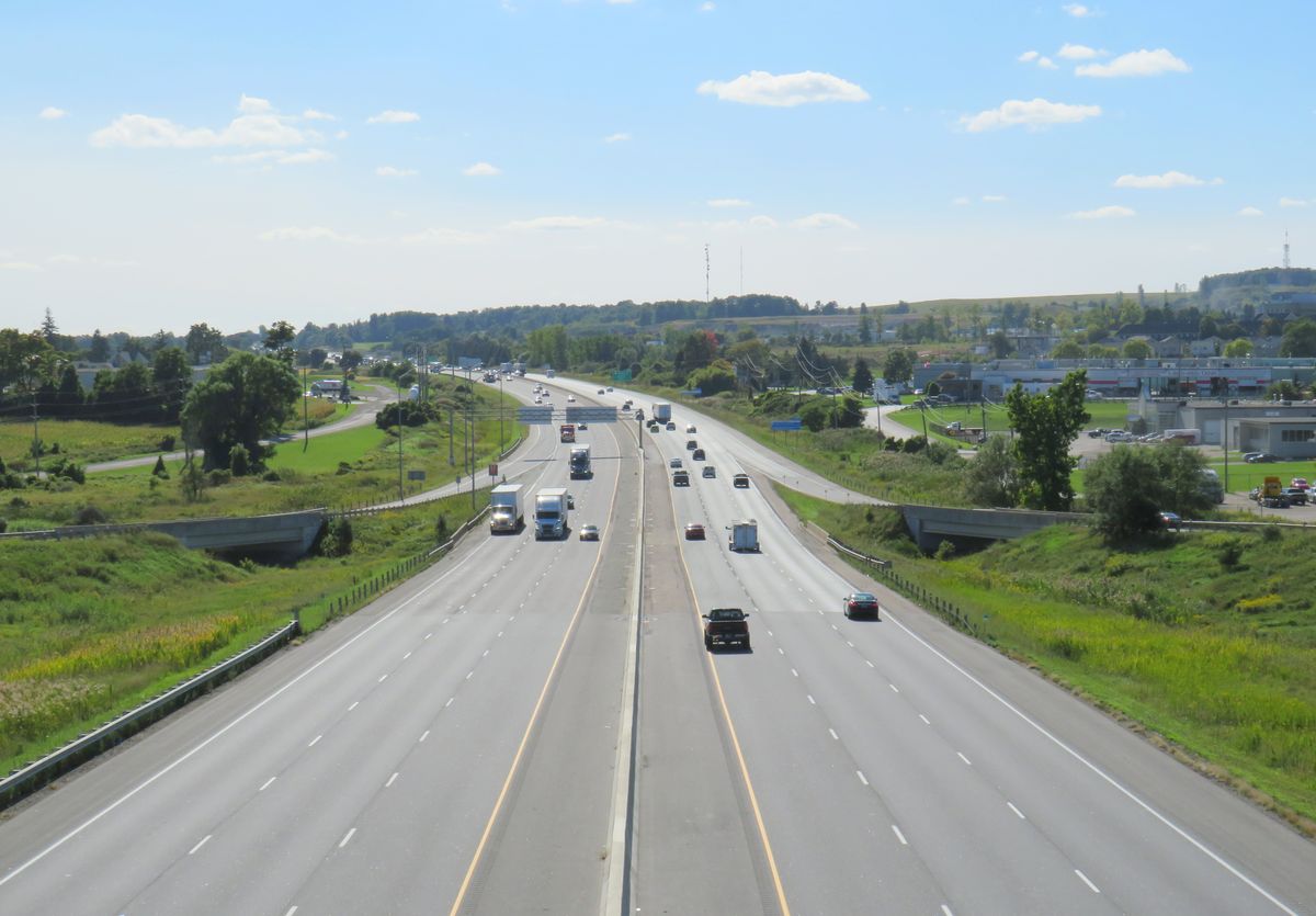 Highway 401 traffic flowing through Woodstock, Ontario's industrial corridor